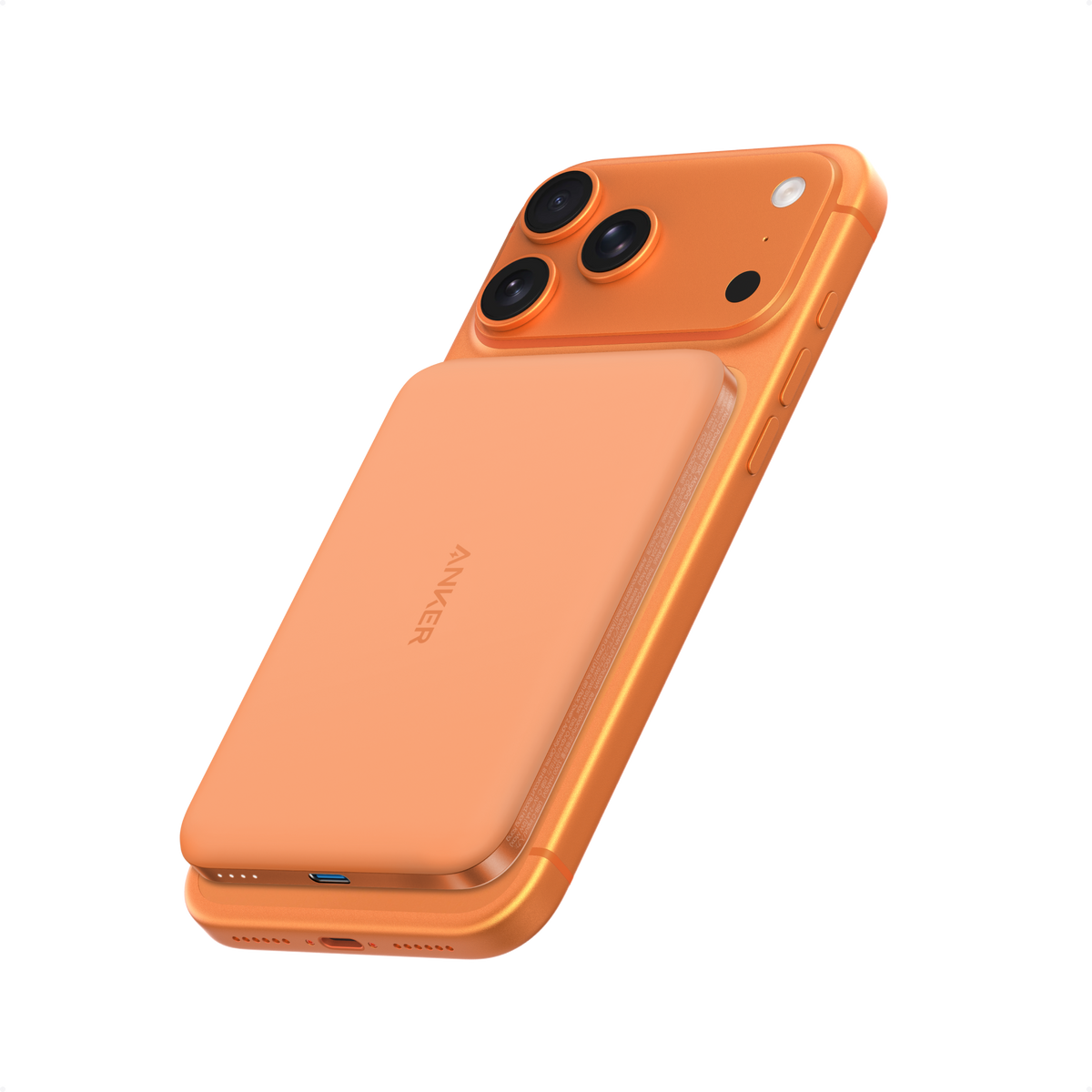 Orange Anker Nano MagGo 5K power bank attached to the back of an iPhone.