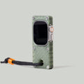 Olive green miniPhone Ultra case holding an Apple Watch Ultra, with a black cord and orange bead.